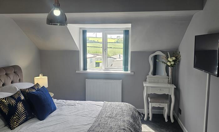 The Redford Cwtch Lounge – a cosy, welcoming space with soft seating, warm lighting, and rustic charm, perfect for relaxing with family or friends aft